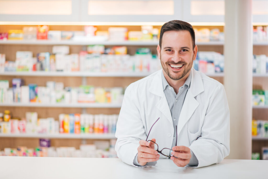 smiling pharmacist providing antibiotics from a virtual dentist appointment